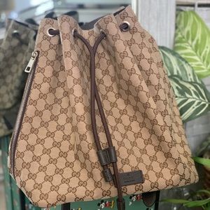 Authentic Gucci Brown GG Monogram Canvas drawstring backpack shoulder bag.